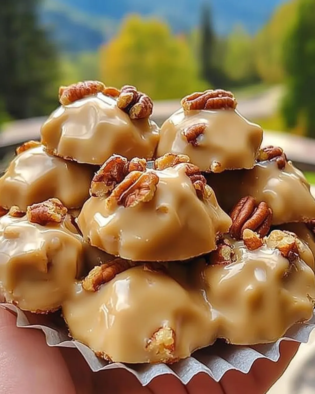 Buttermilk pralines with pecans on parchment paper.