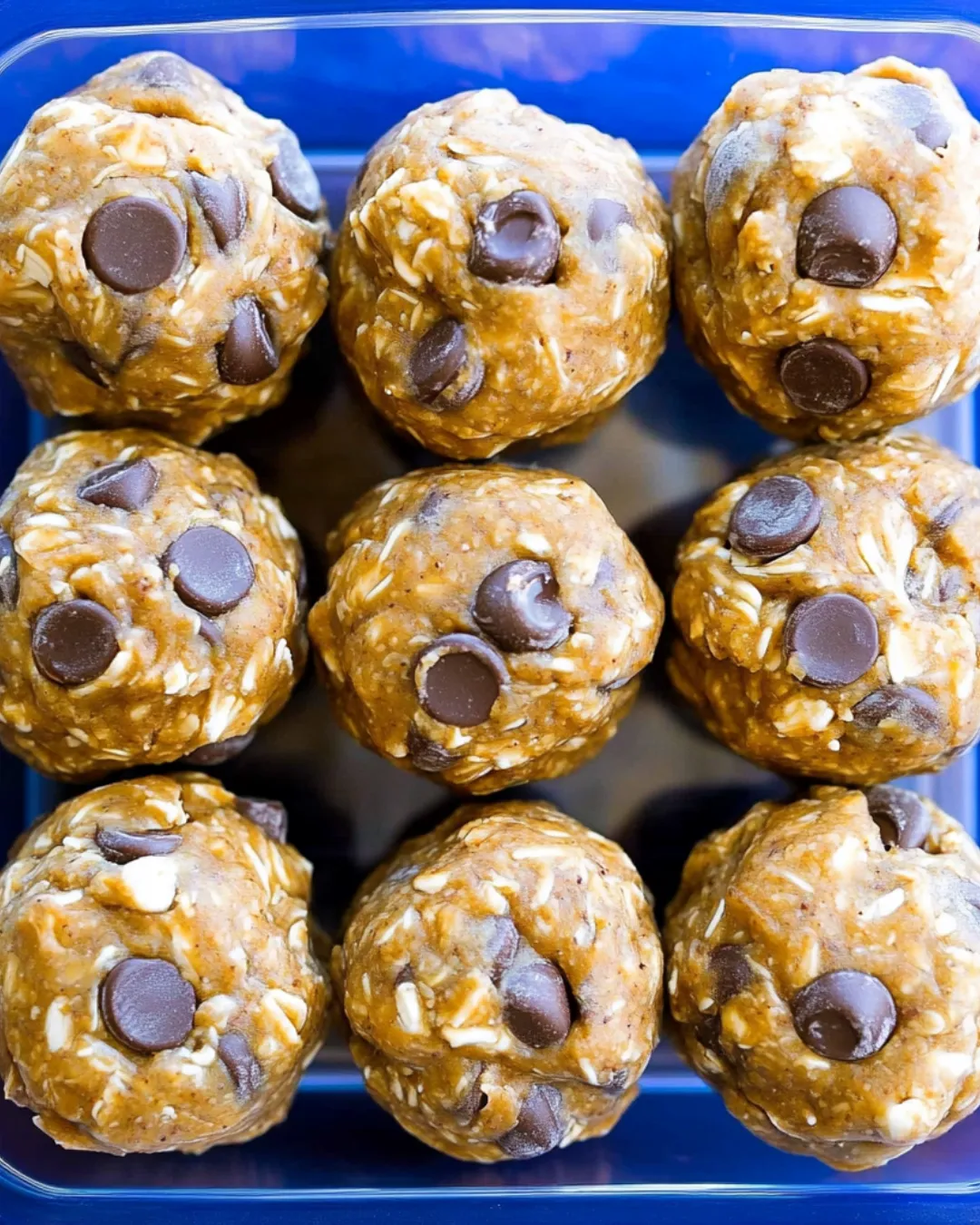 No-Bake Energy Balls made with oats, peanut butter, honey, and chocolate chips on a plate.