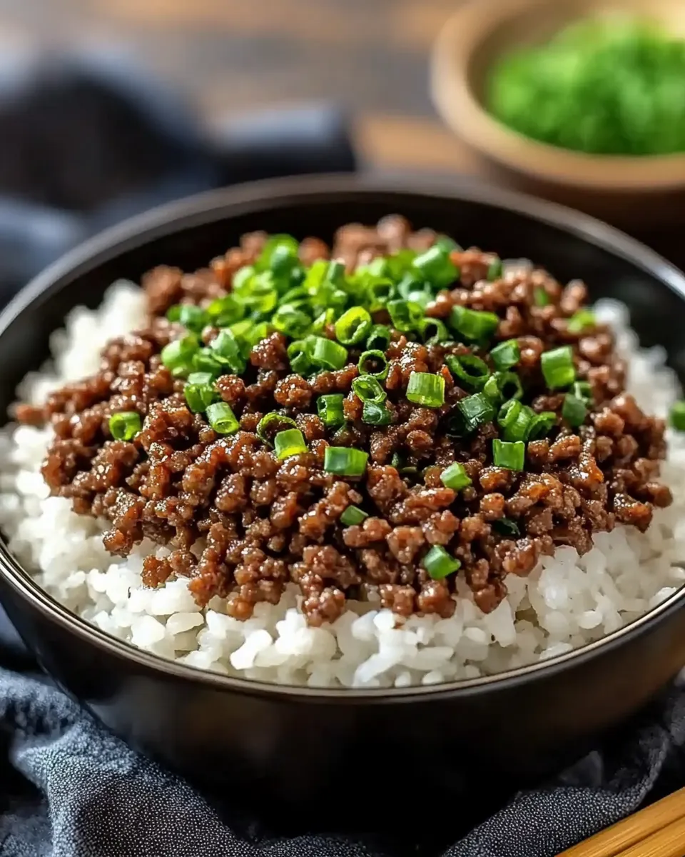 Korean Ground Beef Bowl with white rice, garnished with sesame seeds and green onions.