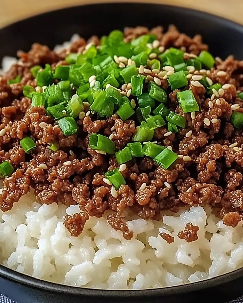 Korean Ground Beef Bowl with white rice, garnished with sesame seeds and green onions.