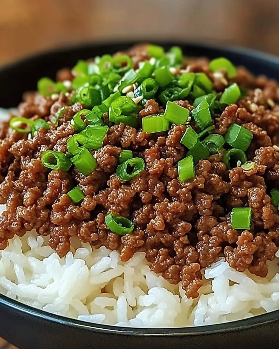 Korean Ground Beef Bowl with white rice, garnished with sesame seeds and green onions.