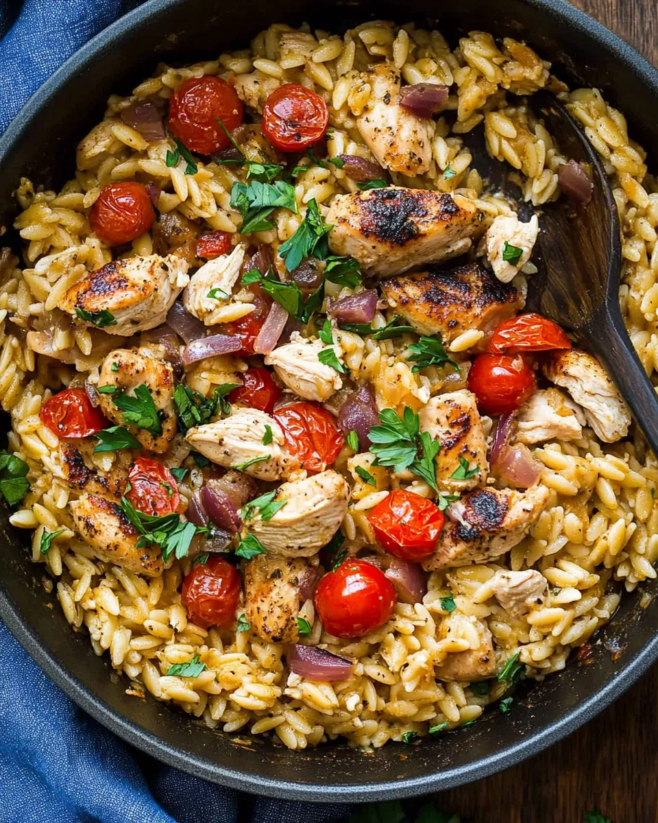Easy Mediterranean Chicken and Orzo with juicy chicken, tomatoes, spinach, and feta in a flavorful one-pan dish.