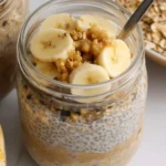 A jar of creamy Brown Sugar Overnight Oats topped with cinnamon and a drizzle of maple syrup.