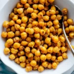 Golden, crispy roasted chickpeas served in a bowl, perfectly seasoned for a crunchy and healthy snack.