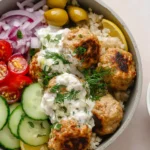 Mediterranean bowl with turkey meatballs, fresh veggies, and a drizzle of creamy dressing.