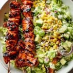 BBQ Chicken Skewer Salad with ranch dressing and fresh vegetables on a plate.
