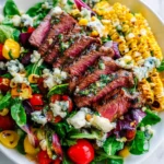 Grilled Corn Balsamic Steak Salad with Gorgonzola cheese and cherry tomatoes.