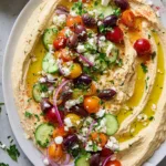 Greek style loaded hummus with vegetables and herbs