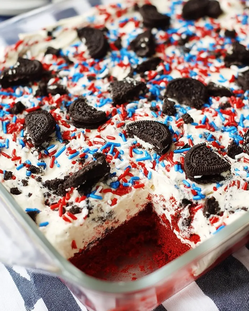 Colorful No Bake Fireworks Oreo Cheesecake Bars topped with whipped cream and red, white, and blue sprinkles, layered on a crushed Oreo crust and served on a festive tray.