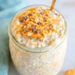 Creamy Peanut Butter Overnight Oats in a jar topped with banana slices and chia seeds