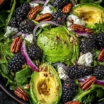Fresh blackberry and avocado salad with baby greens and lemon vinaigrette in a bowl