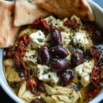 Baked Mediterranean feta with olives and pita