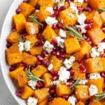 Roasted butternut squash with goat cheese, pomegranate seeds, and rosemary sprigs