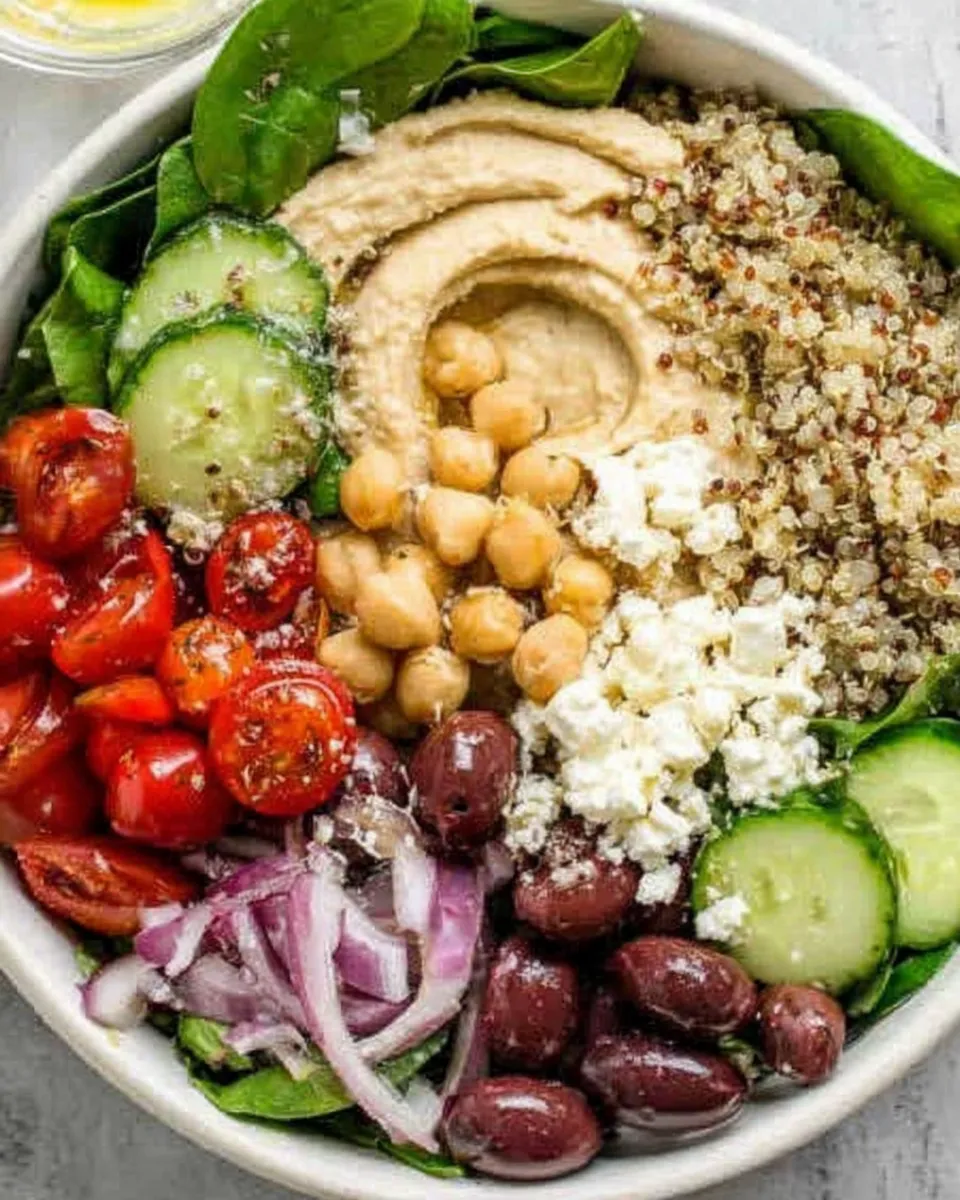 Mediterranean hummus bowl with veggies, olives, and pita