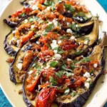 Roasted Eggplant Fan with tomatoes, feta, and basil on ceramic plate
