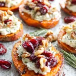 Sweet potato rounds topped with herbed ricotta, cranberries, and walnuts