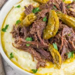 Crockpot Mississippi pot roast with pepperoncini and tender beef in a slow cooker.