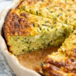 Crustless cottage cheese zucchini quiche baked golden brown and served with fresh herbs.