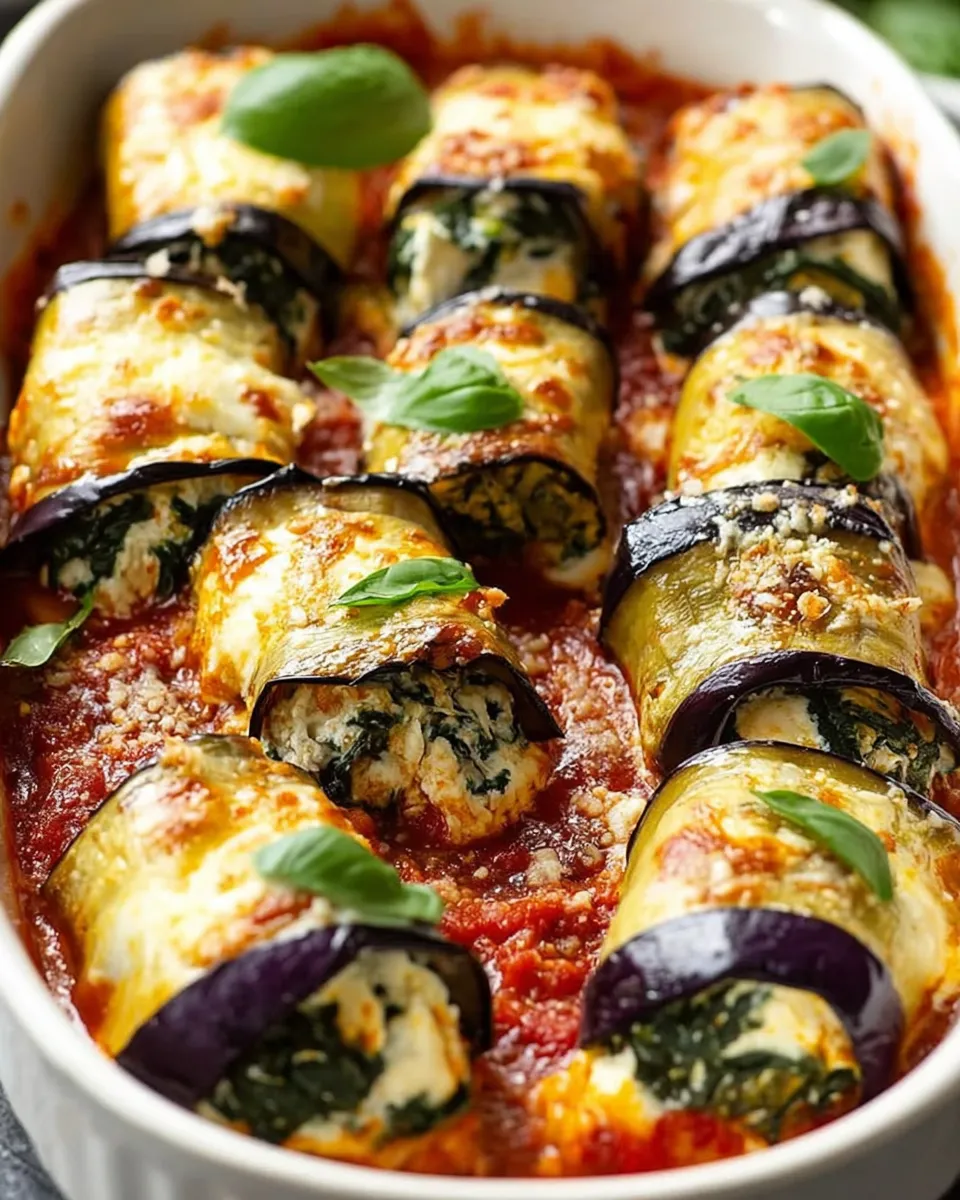 plated eggplant roll-ups with tomato sauce and basil