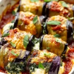 Eggplant roll-ups with creamy ricotta and spinach in a baking dish