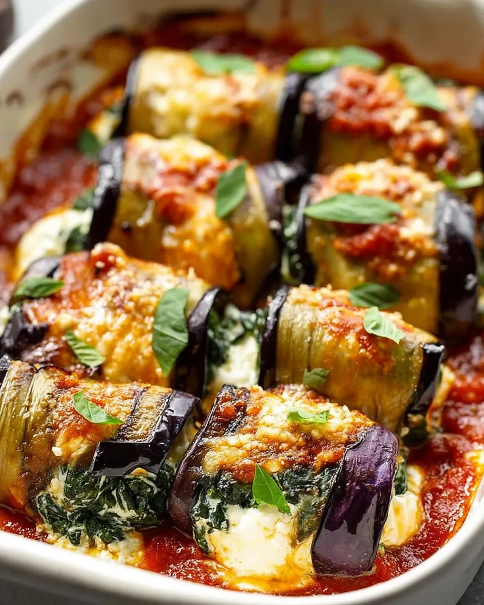 Eggplant roll-ups with creamy ricotta and spinach in a baking dish