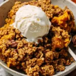 Homemade pumpkin crisp with oat streusel topping served in a baking dish