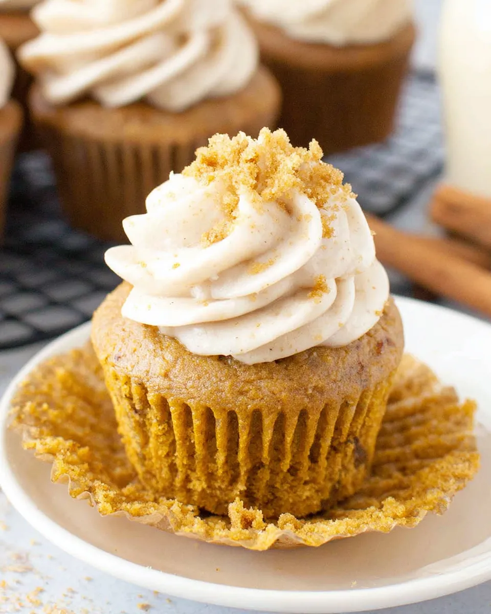 Moist pumpkin cupcakes on rustic fall table