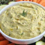 Roasted zucchini hummus in a bowl with pita bread