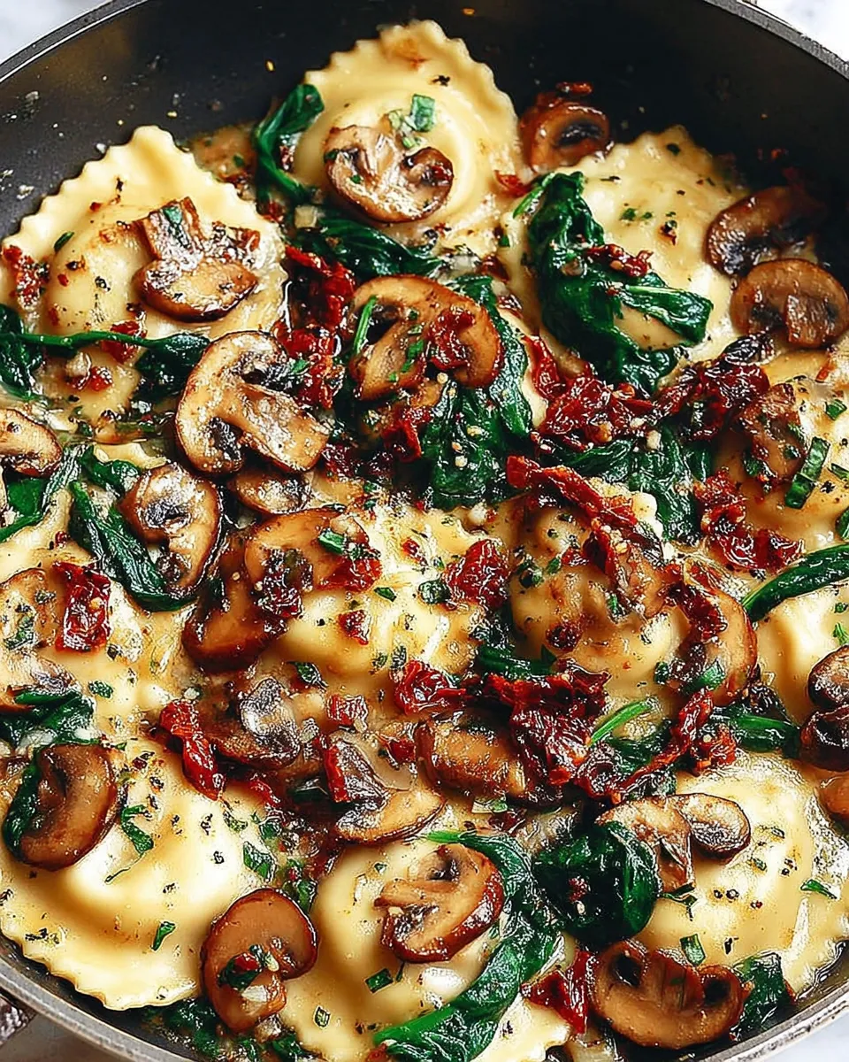 Served cheesy ravioli with mushrooms, spinach, and tomatoes