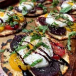 Flatbread with burrata, roasted beets, and orange zest on rustic table