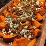 Maple-roasted sweet potatoes in a fall-themed setting with blue cheese and pecans