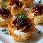 Mini Phyllo Cups with Brie, Pecans and Cranberry Drizzle served on a wooden board