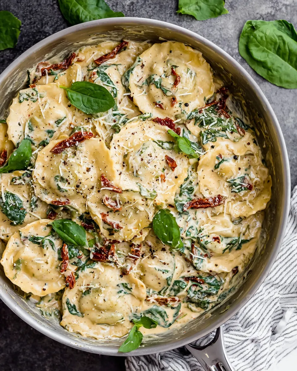 Cooking creamy Tuscan ravioli with spinach